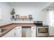 Bright kitchen with white cabinets, stainless steel appliances, and wood countertops at 1912 Broadway St, Anderson, IN 46012