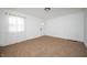 Bright living room featuring neutral carpet, white walls, and a large window with natural light at 1912 Broadway St, Anderson, IN 46012