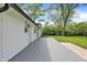 Exterior view of backyard, featuring gray patio, green lawn, and white vinyl siding at 1944 Galeston Ct, Indianapolis, IN 46229
