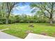 Expansive backyard with picnic table, mature trees, and lush green grass at 1944 Galeston Ct, Indianapolis, IN 46229