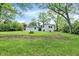 A spacious, grassy backyard featuring a picnic table and mature trees, perfect for outdoor relaxation and entertainment at 1944 Galeston Ct, Indianapolis, IN 46229