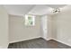 Cozy basement area with natural light from a window, fresh paint, and vinyl flooring at 1944 Galeston Ct, Indianapolis, IN 46229