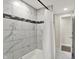 Bright bathroom featuring elegant marble tiles, modern fixtures, and a pristine white shower curtain for a relaxing experience at 1944 Galeston Ct, Indianapolis, IN 46229