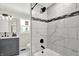 Bathroom showcasing a stylish vanity with marble-look shower and black fixtures at 1944 Galeston Ct, Indianapolis, IN 46229