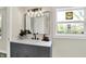 Bathroom featuring a gray vanity, modern lighting, and ample natural light at 1944 Galeston Ct, Indianapolis, IN 46229
