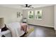 Bedroom with ample natural light, wood-look floors, and a ceiling fan at 1944 Galeston Ct, Indianapolis, IN 46229