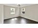 Charming bedroom with two windows, a modern ceiling fan and sleek, dark wood flooring at 1944 Galeston Ct, Indianapolis, IN 46229