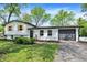 Charming home featuring white siding, black accents, a garage, and well-maintained landscaping at 1944 Galeston Ct, Indianapolis, IN 46229