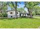 Beautiful home with fresh landscaping, offering curb appeal and a welcoming entrance framed by mature trees at 1944 Galeston Ct, Indianapolis, IN 46229