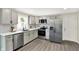 Contemporary kitchen equipped with stainless steel appliances, white countertops, and ample storage at 1944 Galeston Ct, Indianapolis, IN 46229