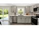 Updated kitchen with stainless steel appliances, stylish cabinetry, and a view of the backyard at 1944 Galeston Ct, Indianapolis, IN 46229