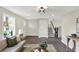 Elegant living room with modern flooring, staircase, and a cozy seating arrangement at 1944 Galeston Ct, Indianapolis, IN 46229