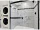 Stylish shower featuring elegant tile work, complemented by the convenience of in-unit laundry appliances at 1944 Galeston Ct, Indianapolis, IN 46229