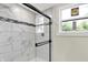 Modern shower with elegant tile work and a sleek glass enclosure, providing a stylish and functional space at 1944 Galeston Ct, Indianapolis, IN 46229