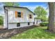 Attractive side view showcasing the home's design, updated siding, fresh landscaping, and neat lawn at 1944 Galeston Ct, Indianapolis, IN 46229