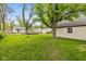 Large backyard with well-maintained lawn, mature trees, and ample space for recreation at 2006 N Moreland Ave, Indianapolis, IN 46222