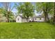 Expansive backyard featuring lush green grass and mature trees, perfect for outdoor activities at 2006 N Moreland Ave, Indianapolis, IN 46222
