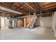 Unfinished basement with exposed ceiling, stairs, and open layout, ready for customization at 2006 N Moreland Ave, Indianapolis, IN 46222