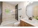 Updated bathroom featuring a shower over tub, modern fixtures, and a stylish vanity at 2006 N Moreland Ave, Indianapolis, IN 46222