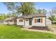 Charming single-story home featuring neutral siding, wood shutters, and a well-maintained yard at 2006 N Moreland Ave, Indianapolis, IN 46222
