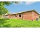 Exterior of the home with lush green lawn and well-maintained brick facade at 217 Devonshire Ct, Anderson, IN 46013