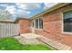 Exterior view of a well-maintained brick house with a ramp and grassy area at 217 Devonshire Ct, Anderson, IN 46013