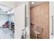 Tiled walk-in shower with seat and grab bars, adjoining to a room with rocker and work table at 217 Devonshire Ct, Anderson, IN 46013