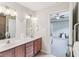 This is bathroom with double vanity, tile floors, and a view into an adjacent room at 217 Devonshire Ct, Anderson, IN 46013