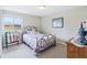 Cozy bedroom with metal frame bed, window with natural light, and light gray walls at 217 Devonshire Ct, Anderson, IN 46013