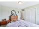 Bedroom featuring a decorative metal bed frame and view to a dresser with round mirror at 217 Devonshire Ct, Anderson, IN 46013