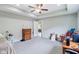 Spacious bedroom featuring neutral walls, ceiling fan, and an open doorway to an adjacent room at 217 Devonshire Ct, Anderson, IN 46013