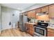 Kitchen features stainless steel appliances, tile countertops and wood finish cabinetry at 217 Devonshire Ct, Anderson, IN 46013