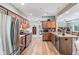 The well-lit kitchen features stainless steel appliances, wooden cabinets, and laminate flooring at 217 Devonshire Ct, Anderson, IN 46013