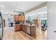 View of the open kitchen with stainless appliances, wooden cabinetry, and eat-in bar area at 217 Devonshire Ct, Anderson, IN 46013