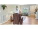 Bright living room with a large window, comfortable seating, and hardwood floors at 217 Devonshire Ct, Anderson, IN 46013
