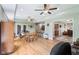 Open-concept living room features hardwood floors, ceiling fans, and access to the kitchen and a sunroom at 217 Devonshire Ct, Anderson, IN 46013