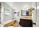 Bright bathroom with a freestanding tub, vintage vanity, and window at 218 Pearl St, Fortville, IN 46040