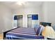 Well-lit bedroom featuring two closets and a striped bedspread with matching pillows at 218 Pearl St, Fortville, IN 46040