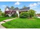 Charming home with a well-manicured lawn, stone pathway, and mature trees enhancing the curb appeal at 218 Pearl St, Fortville, IN 46040