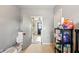 View of the hallway shows storage shelf, and the door leads to a bright laundry room at 218 Pearl St, Fortville, IN 46040