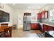 Bright kitchen features stainless steel appliances, wooden cabinetry, and adjacent dining area at 218 Pearl St, Fortville, IN 46040