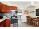 Open kitchen showcases stainless steel appliances, tiled floors, and adjacent dining space at 218 Pearl St, Fortville, IN 46040