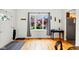 Bright living room with hardwood floors, large bay window, and elegant curtains at 218 Pearl St, Fortville, IN 46040