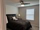 Comfortable bedroom features a ceiling fan and large window with blinds at 230 Kiawah Dr, Whiteland, IN 46184