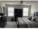 Bedroom featuring bed, dresser, and two windows that allow natural light in at 230 Kiawah Dr, Whiteland, IN 46184