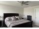 Bedroom with large bed, bedside tables, a ceiling fan and a dark-wood bedframe at 230 Kiawah Dr, Whiteland, IN 46184