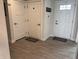 Inviting entryway featuring three doors and modern flooring at 230 Kiawah Dr, Whiteland, IN 46184