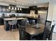 Kitchen with black cabinets, granite countertops, stainless appliances open to dining area at 230 Kiawah Dr, Whiteland, IN 46184