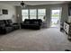 Cozy living room with plush carpeting, comfortable seating, and a view of the water at 230 Kiawah Dr, Whiteland, IN 46184