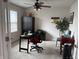 Cozy home office featuring a ceiling fan, black desk, and a comfortable red office chair at 230 Kiawah Dr, Whiteland, IN 46184